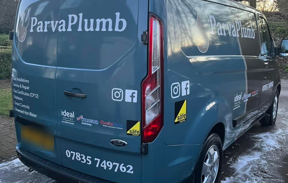 The teal ParvaPlumb van, its back doors listing gas installations, service and repair, gas certificates, radiators, smart controls and unvented hot water